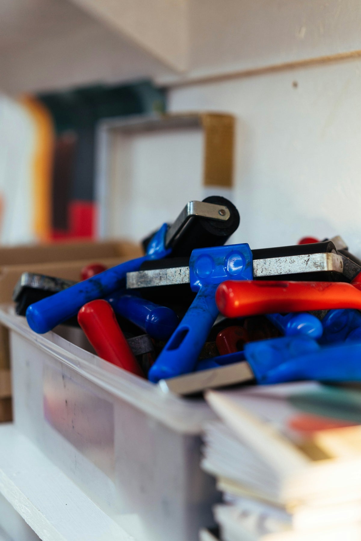 A box is filled with paint rollers.